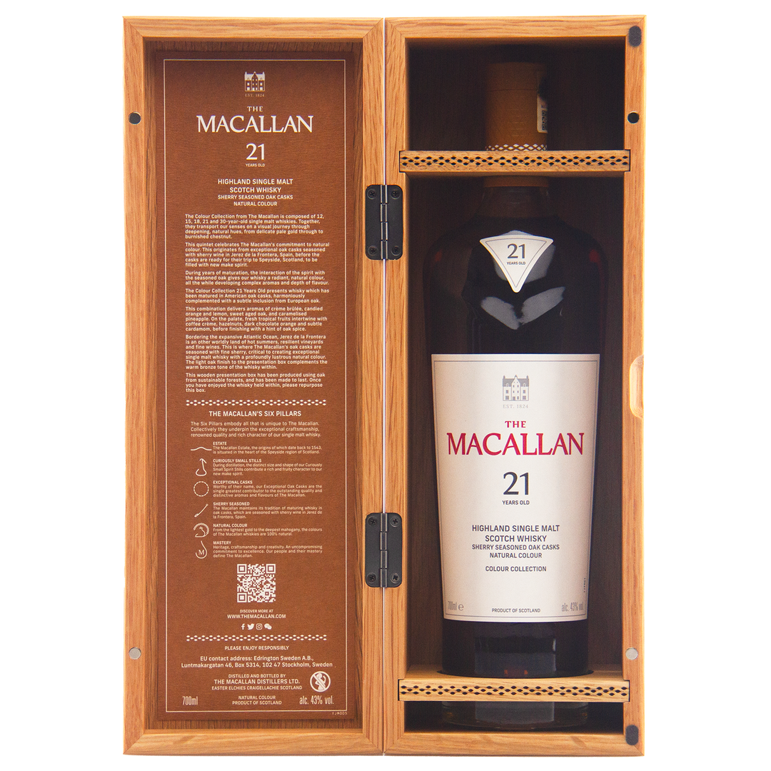 A bottle from The Macallan Colour Collection 21 Year Old, part of the Colour Collection 12,15,18,21 Year Olds line, stands upright in an open wooden box noting its sherry-seasoned oak maturation inside the lid.