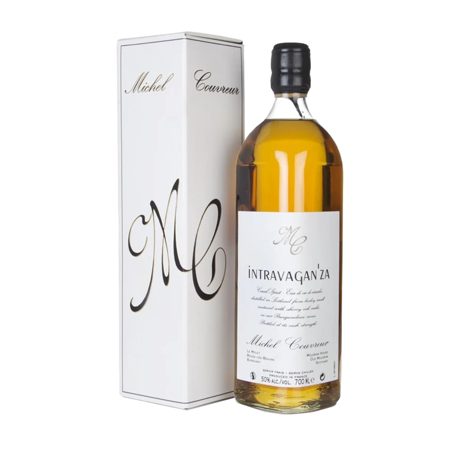 A bottle of Michel Couvreur Intravagan’za French whisky is displayed beside its white rectangular box, both adorned with elegant black script on a minimalist background—highlighting the sherry cask matured character.