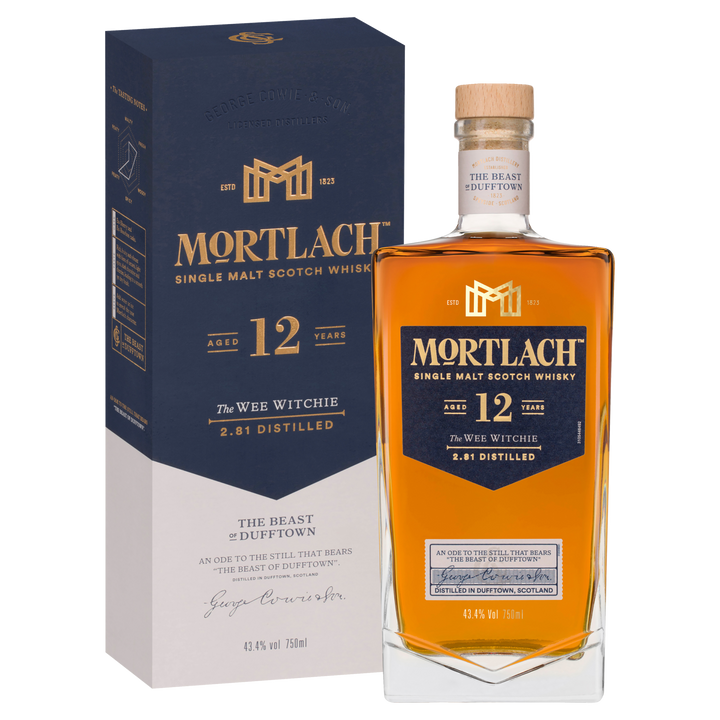 A bottle of Mortlach 12 Year Old Single Malt Scotch Whisky stands before its blue and cream box. The label features The Wee Witchie and 2.81 Distilled, expressing the Speyside spirit in a rich amber hue.