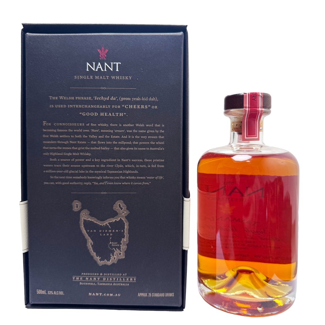 Nant Single Malt Whisky bottle with amber liquid next to its dark navy blue packaging box, featuring the Nant logo and product information.