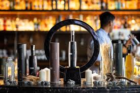 Bar setup with various bottles and a person in the background