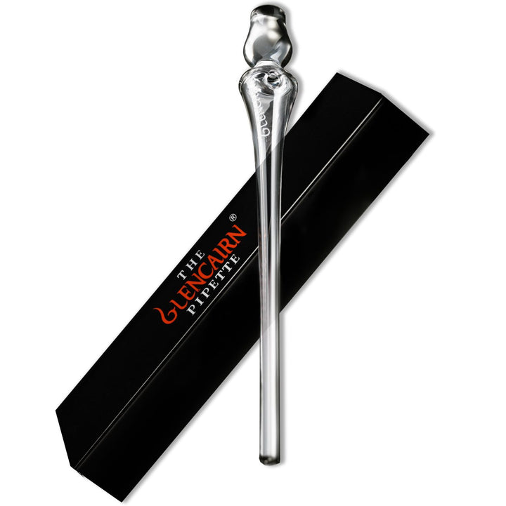 A clear glass Glencairn Water Pipette with a bulbous end is placed next to a black rectangular box labeled "Glencairn Water Pipette" in white and orange text.