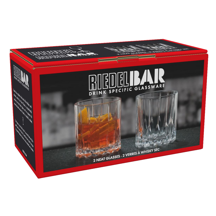 A red and black RIEDEL Neat Whisky Glass Set of 2 box displays two glasses—one with an amber drink and ice, one empty. The set includes two whisky glasses, ideal for spirit-focused cocktails.