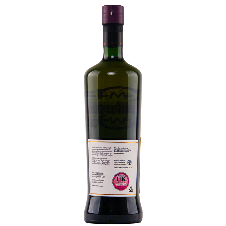 A dark green glass bottle with a tall neck and purple cap is shown from the back. The pink UK duty stamp and recycling icon on the label identify it as SMWS 138.5 Delicate Masculinity whisky from the Scotch Malt Whisky Society. Plain white background.