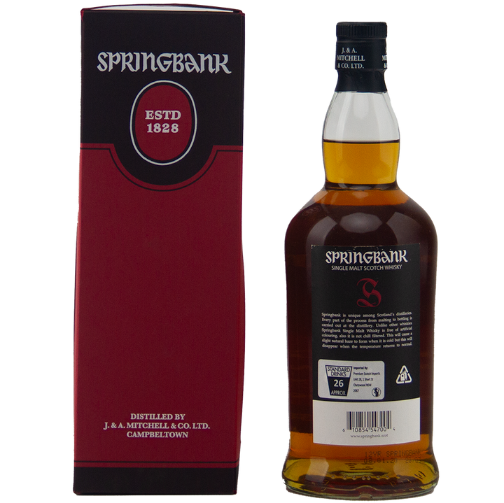 A bottle of Springbank 12 Year Old Cask Strength 55.3% sits beside its red and black box, displaying the brand name, "Established 1828," and distillery info. The bottle’s back label is also visible.