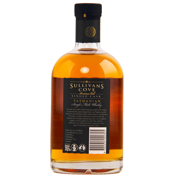 A 700ml bottle of Sullivans Cove American Oak Ex-Bourbon Single Cask TD0353, filled with amber whisky and sealed with a black cap, highlights its ex-bourbon heritage. The back label displays product details and a barcode.