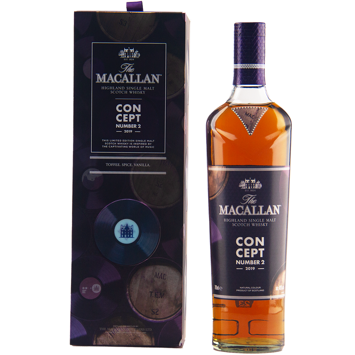 A bottle of The Macallan Concept Number 2 Single Malt Scotch Whisky stands beside its purple and gold box with barrel motifs. The label notes toffee, spice, and vanilla flavors.