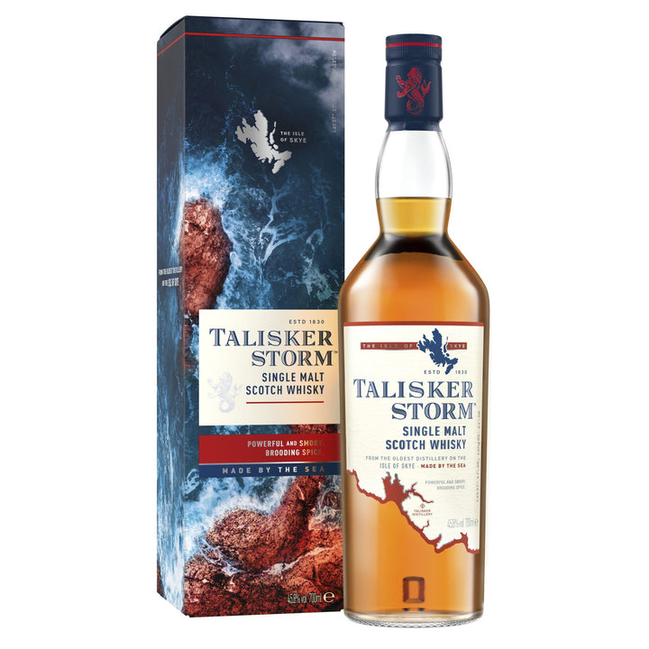 A bottle of Talisker Storm Single Malt Scotch Whisky is shown beside its box, both bearing the Talisker logo and smoky whisky branding, with the box featuring a dramatic stormy ocean wave design.