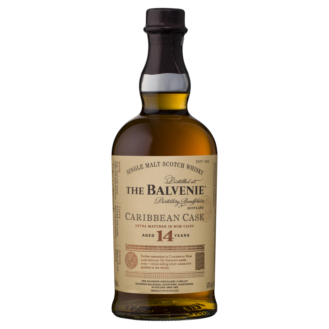 A bottle of The Balvenie Caribbean Cask 14 Year Old Single Malt Scotch Whisky, finished in rum casks, with a cream label featuring gold and black text highlighting its unique Speyside aging process.