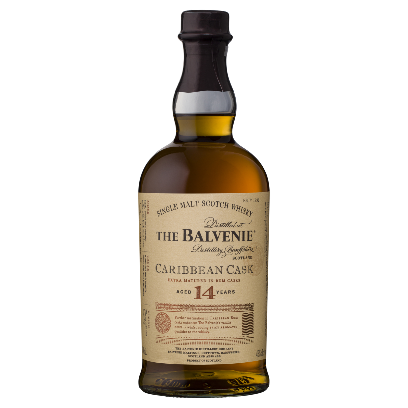 A bottle of The Balvenie Caribbean Cask 14 Year Old Single Malt Scotch Whisky, finished in rum casks, with a cream label featuring gold and black text highlighting its unique Speyside aging process.