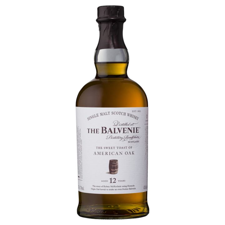 A bottle of The Balvenie Stories The Week of Peat 14 Year Old Single Malt Scotch Whisky, featuring a dark cap and clear glass revealing amber liquid—a perfect choice for single malt Scotch whisky enthusiasts.