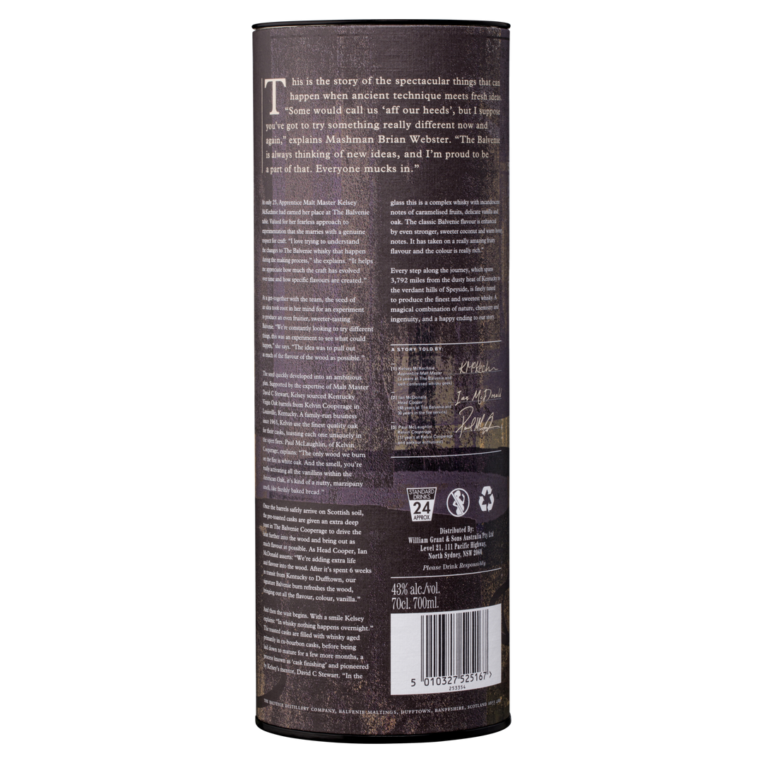 A cylindrical container features text about The Balvenie Stories The Week of Peat 14 Year Old Single Malt Scotch Whisky, its story, sustainability certifications, recycling icons, barcode, and 40% ABV. The dark background is rustic textured.
