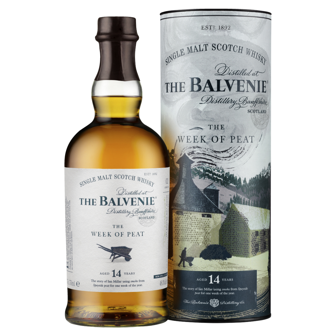 A bottle of The Balvenie Stories The Week of Peat 14 Year Old Single Malt Scotch Whisky is displayed in front of its cylindrical packaging, which features distillery-themed imagery and branding.