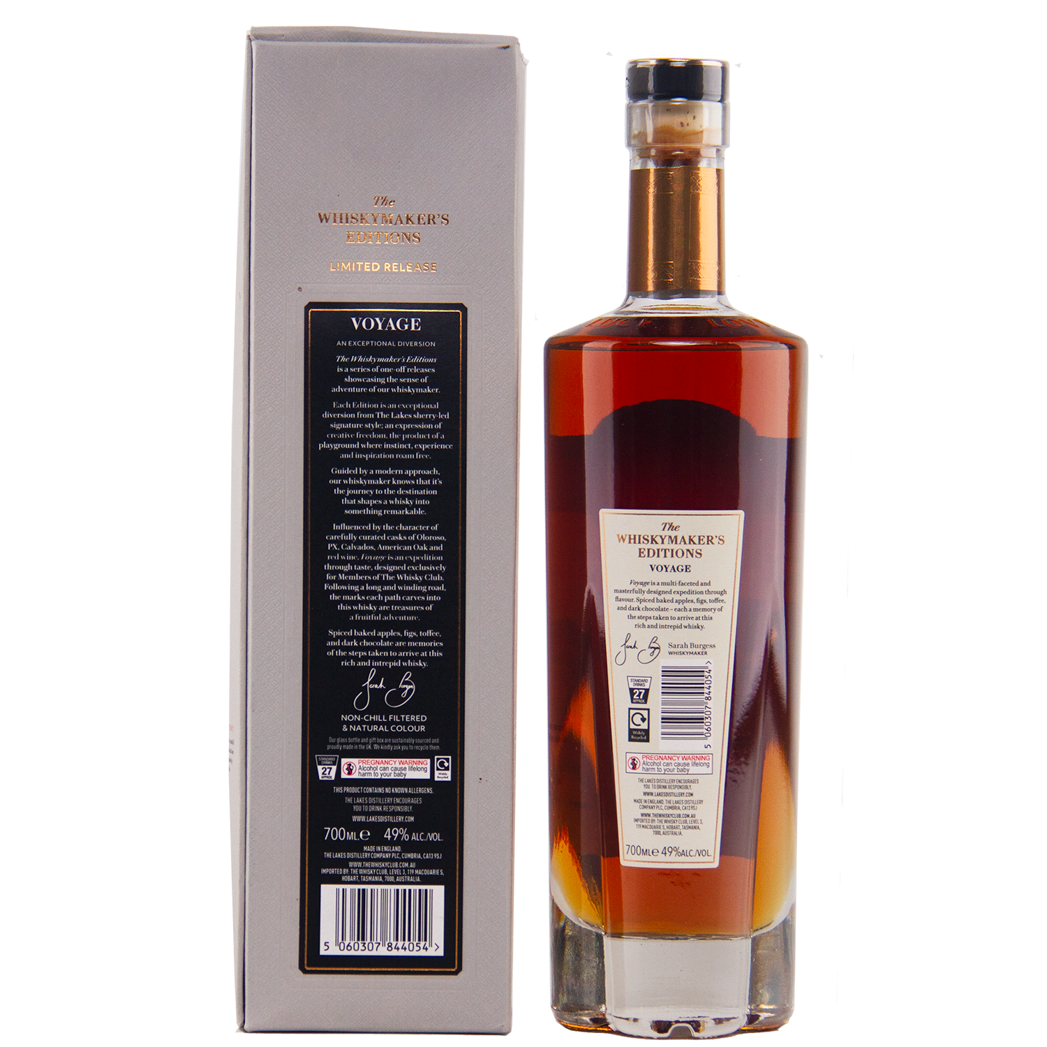 A bottle of The Lakes Whiskymaker’s Editions: Voyage Single Malt Whisky with amber liquid and a dark cap stands beside its silver-grey box, both bearing detailed labels that showcase the craftsmanship of The Lakes Distillery.