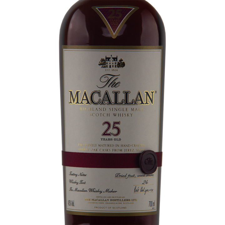 Close-up of The Macallan 25 Year Old Sherry Oak Single Malt Scotch Whisky (Pre-2018) bottle, showcasing its maroon and gold label with age, sherry oak cask maturation, and detailed whisky info on the front.