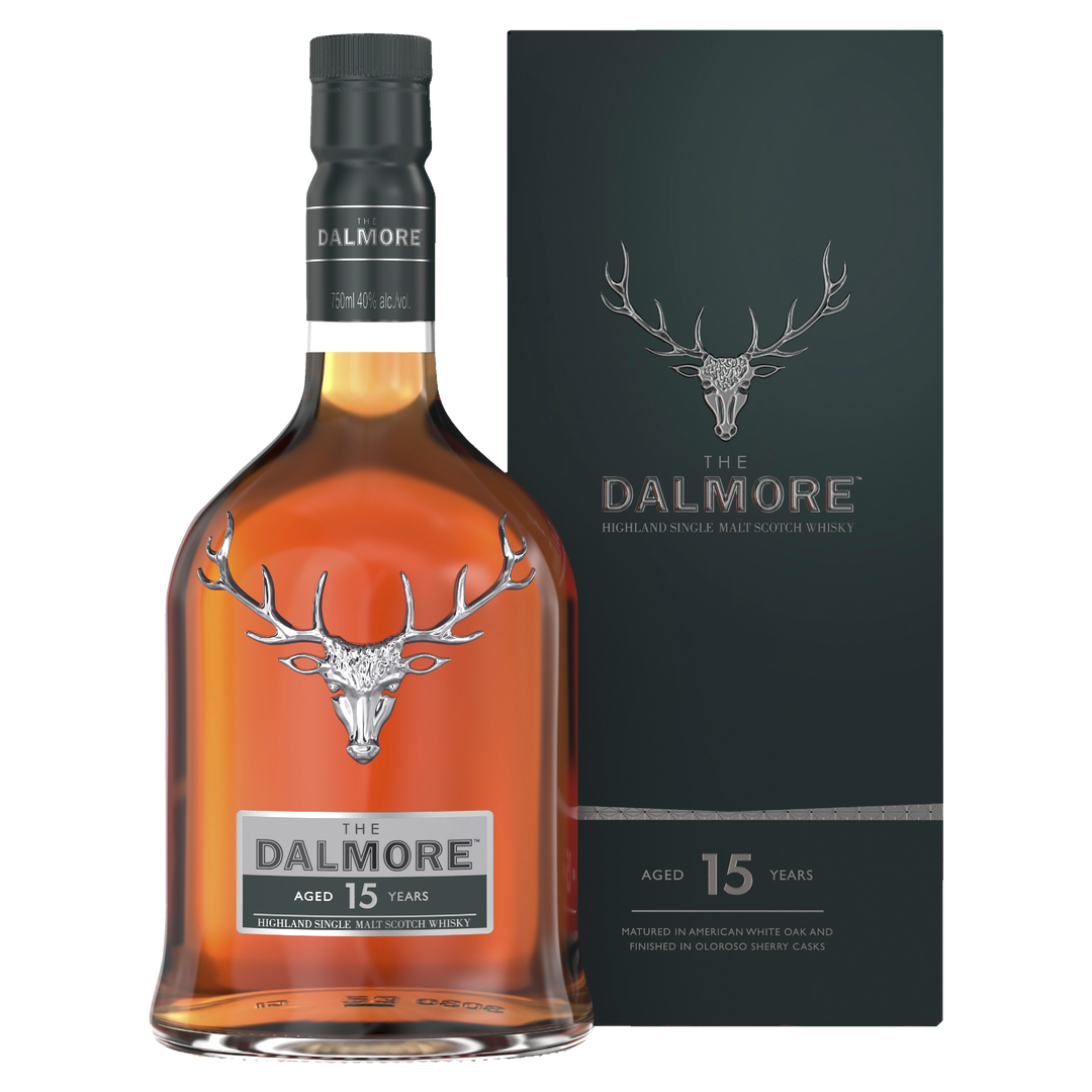 A bottle of The Dalmore 15 Year Old 2007 Vintage Single Malt Scotch Whisky with a dark green box, both featuring the silver stag logo and text noting the whisky’s 15 years of aging.