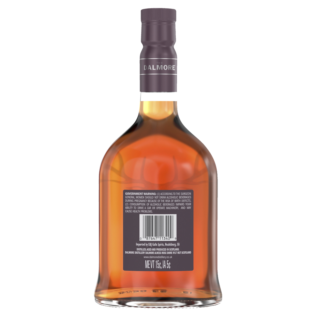 A bottle of The Dalmore Port Wood Reserve Single Malt Scotch Whisky seen from the back, displaying the barcode, government warning label, and amber liquid. The bottle features a purple cap and has a rounded, elegant shape.