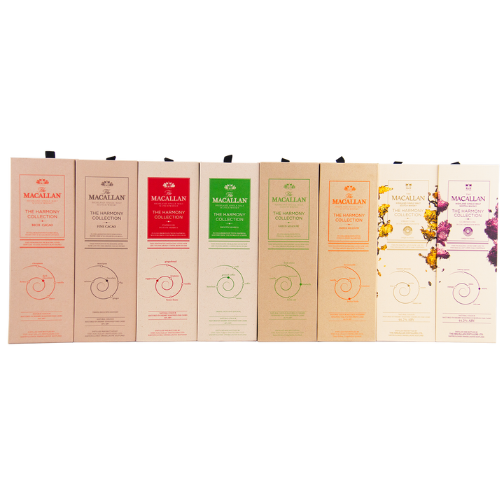 Collection of Macallan whisky boxes in various colors on a white background