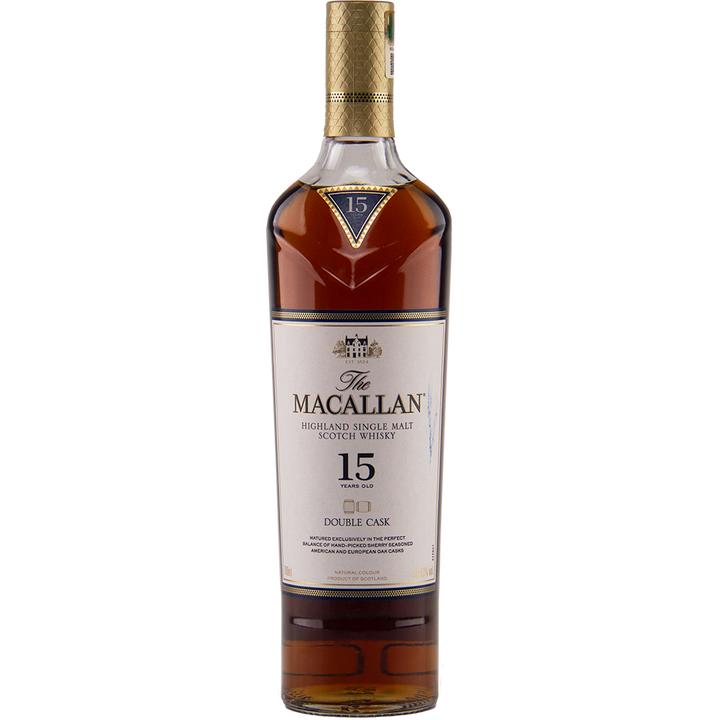 A bottle of The Macallan 15 Year Old Double Cask Single Malt Whisky with a gold cap and a white label displaying black and gold text.