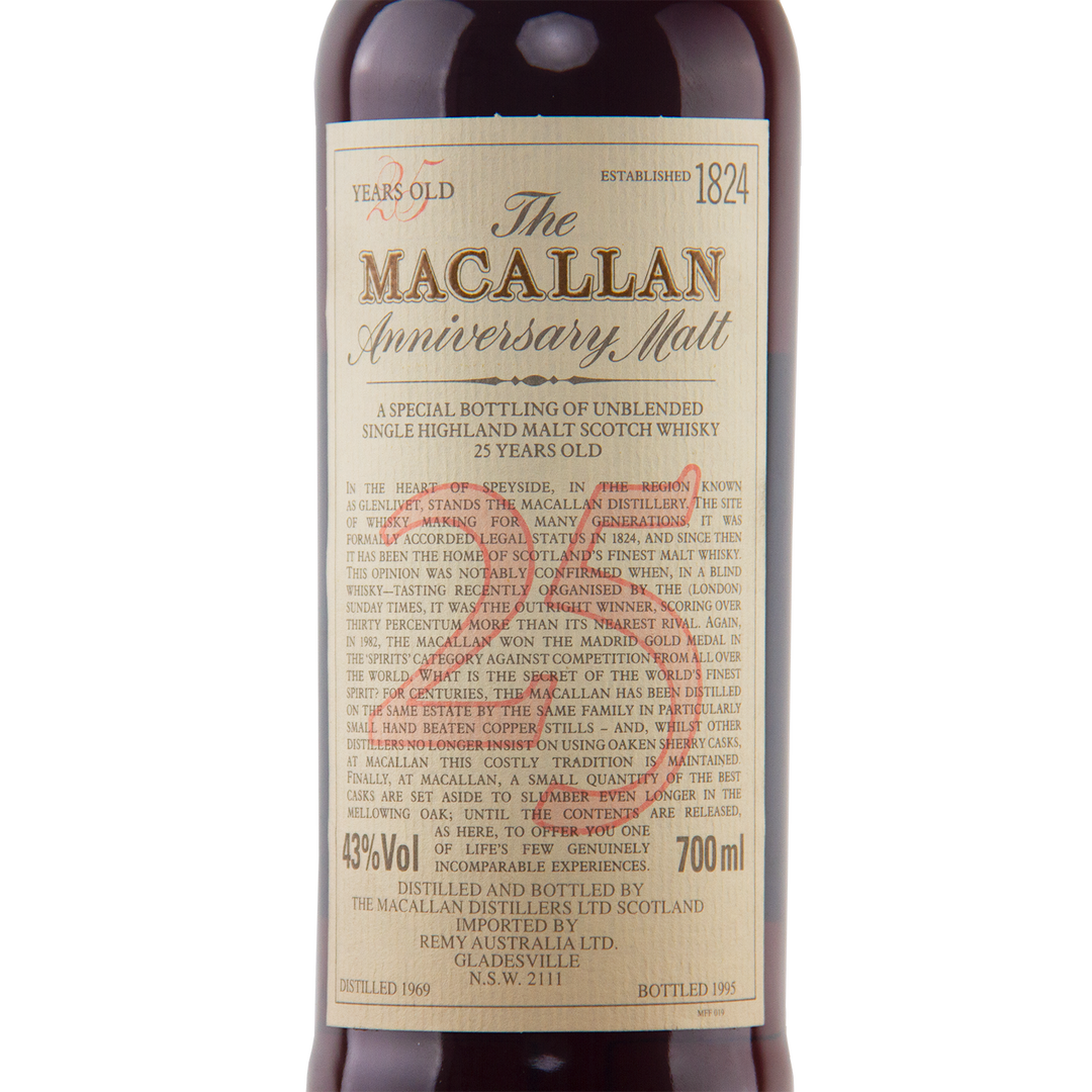 A close-up of The Macallan 1969 25 Year Old Anniversary Edition single malt, aged in sherry casks. The cream label shows its 700ml volume, 43% ABV, and the distillation and bottling years.