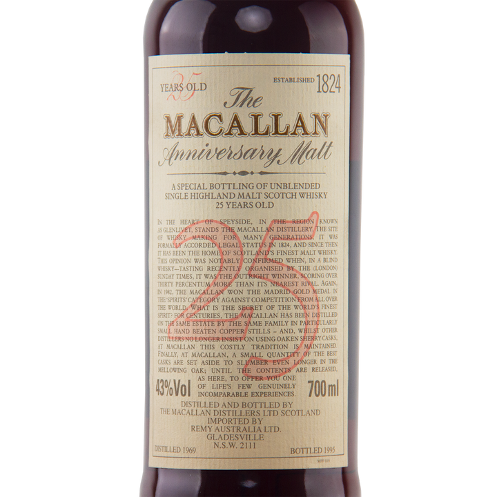 A close-up of The Macallan 1969 25 Year Old Anniversary Edition single malt, aged in sherry casks. The cream label shows its 700ml volume, 43% ABV, and the distillation and bottling years.