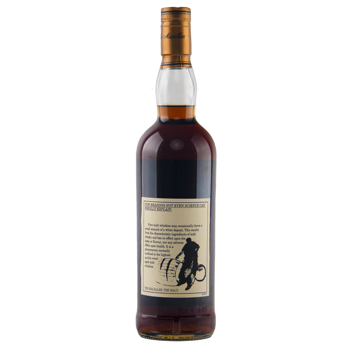 A clear glass bottle of dark brown whisky with a gold cap stands against a plain white background. The label reads "The Macallan 1969 25 Year Old Anniversary Edition" and features a silhouette of a man on a bicycle with sherry cask notes below.