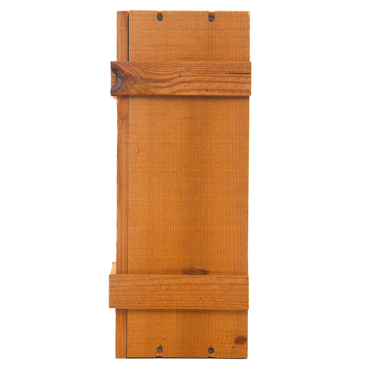 A rectangular wooden plank, featuring natural wood grain like a sherry cask and visible screws, evokes the craftsmanship of The Macallan 1969 25 Year Old Anniversary Edition.