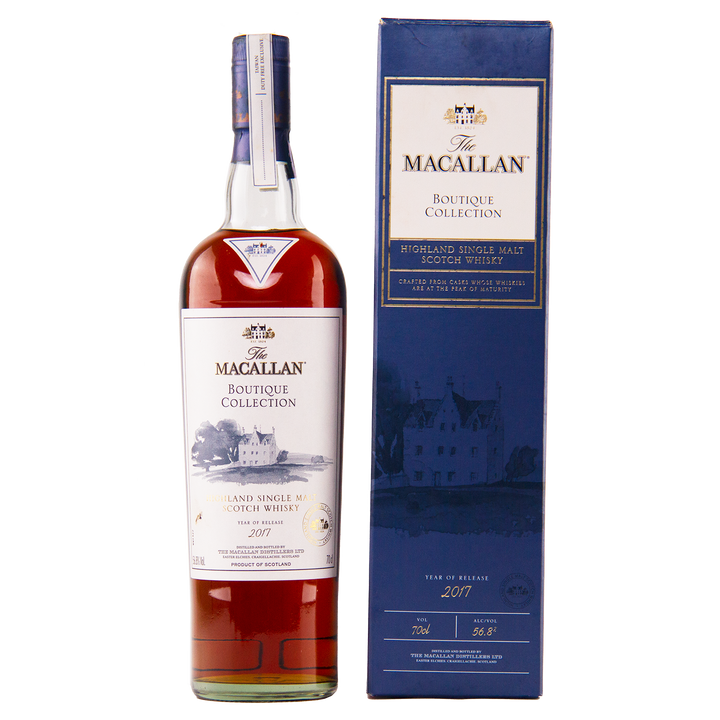A bottle of The Macallan Boutique Collection 2017 Single Malt Whisky, a travel retail exclusive, stands beside its blue box featuring gold and white text plus a building illustration—one of the limited Macallan releases.