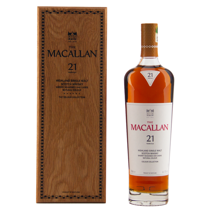 A bottle from The Macallan Colour Collection Set stands beside its wooden box, both featuring elegant black and gold branding—reflecting the rich influence of sherry-seasoned oak maturation.