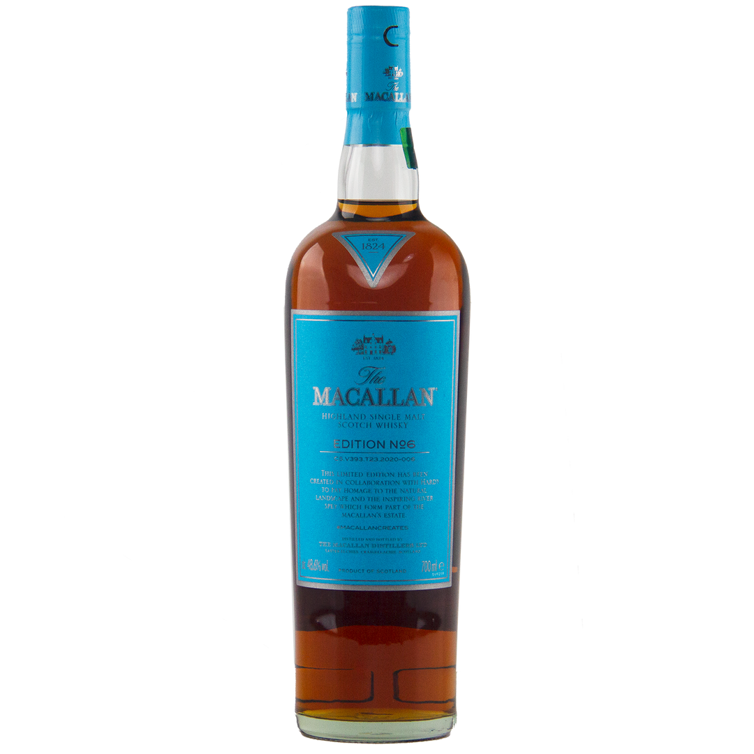 A bottle of The Macallan Edition 6 Single Malt Scotch Whisky, with its distinctive blue label and cap, stands upright against a plain white background.