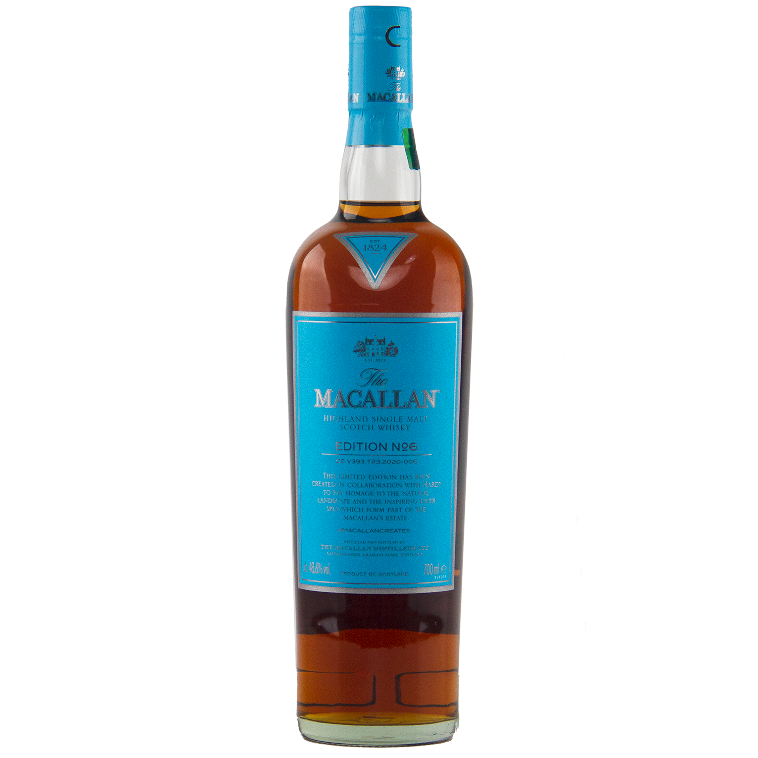 A bottle of The Macallan Edition 6 Single Malt Scotch Whisky, with its distinctive blue label and cap, stands upright against a plain white background.