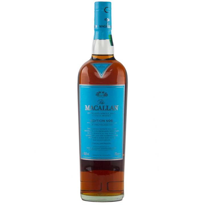 A bottle of The Macallan Edition 6 Single Malt Scotch Whisky, with its distinctive blue label and cap, stands upright against a plain white background.