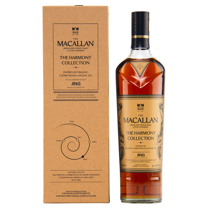 A bottle of The Macallan Harmony Collection Jing Single Malt Scotch Whisky is shown beside its brown box, both featuring black text and graphics. The label highlights inspiration from aromatic cherrywood lapsang tea and travel retail exclusivity.