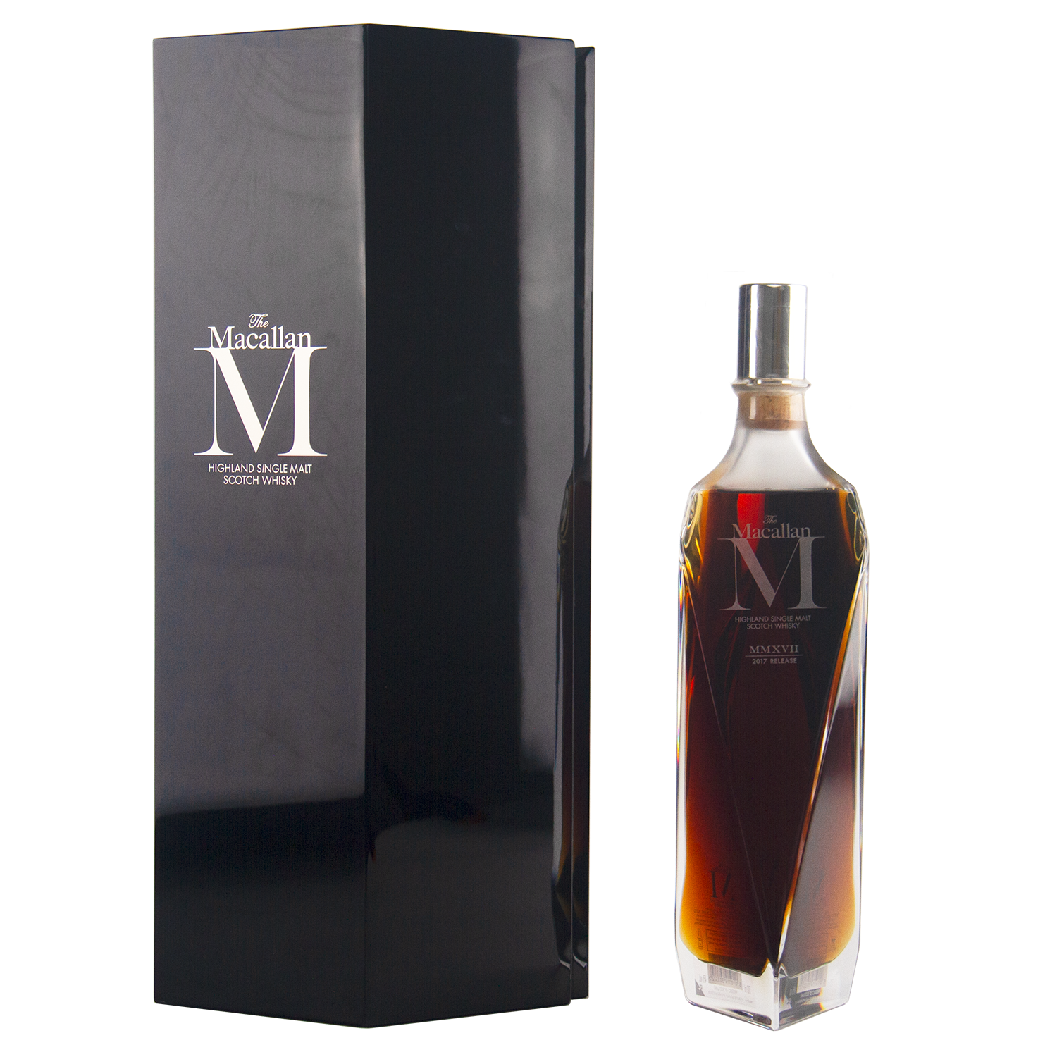 A sleek, angular bottle of The Macallan M (2017 First Release) Single Malt Scotch Whisky stands beside a tall black box, both with elegant silver branding—a tribute to sherry oak maturation.