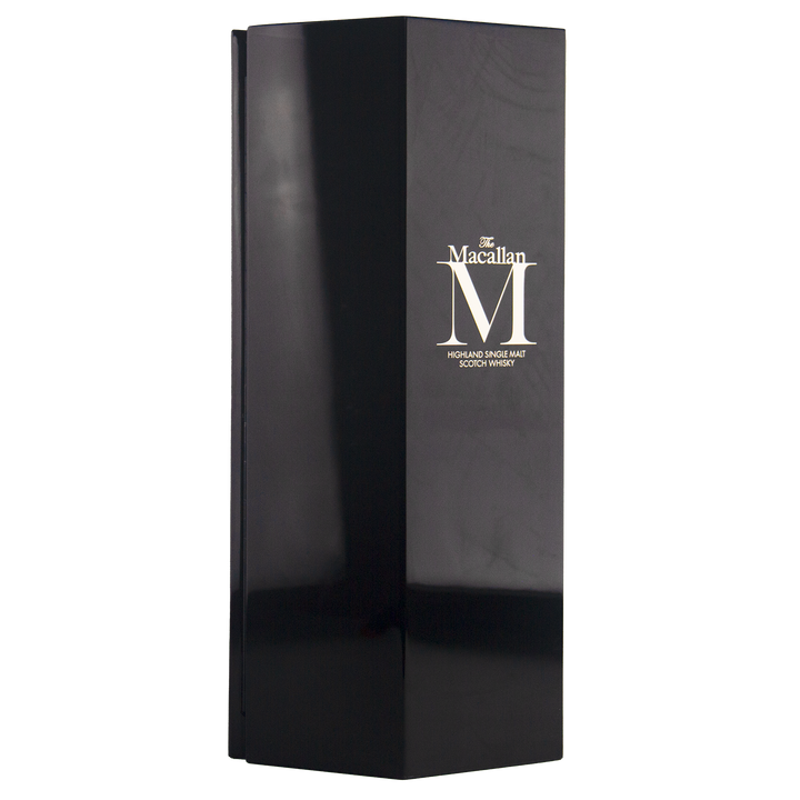 A tall, glossy black box with minimal design and gold text showcases The Macallan M (2017 First Release) Single Malt Scotch Whisky, reflecting sherry oak maturation and sharp-edged sophistication.