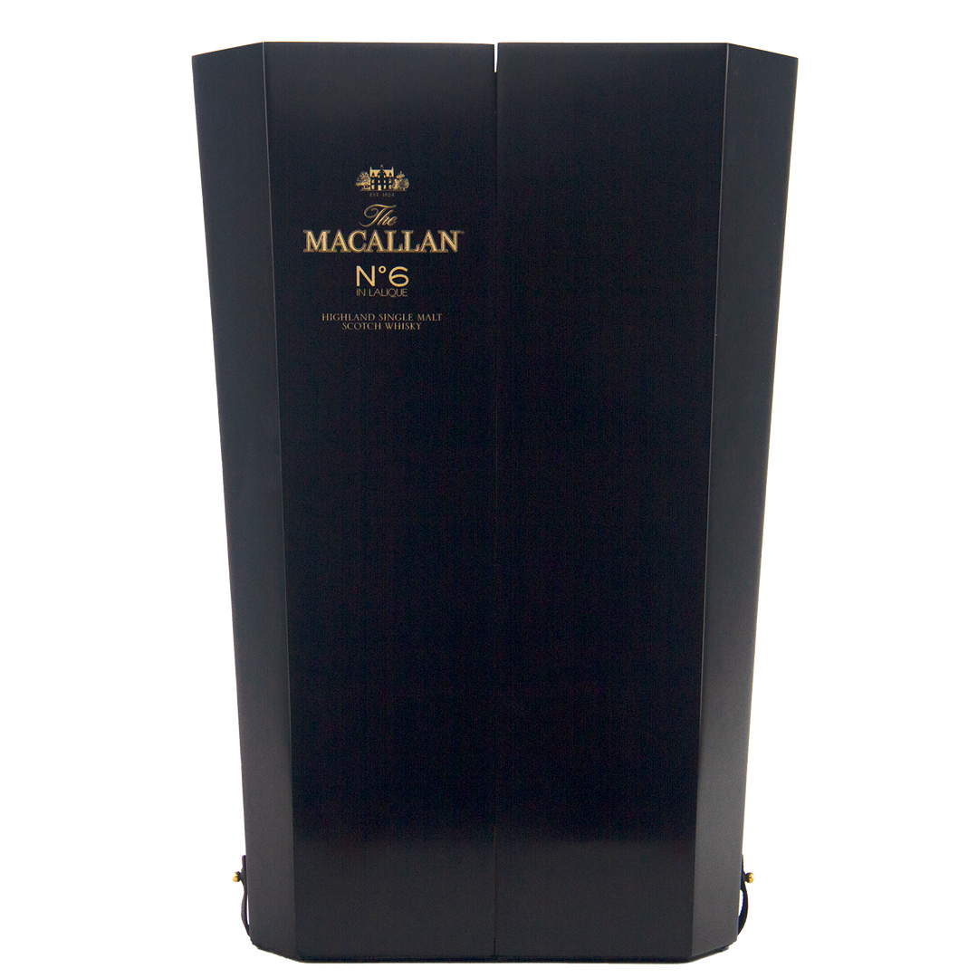 A tall, elegant dark wooden box with gold text reading "The Macallan No 6 Single Malt Scotch Whisky," highlighting its sherry cask maturation, displayed against a plain white background.