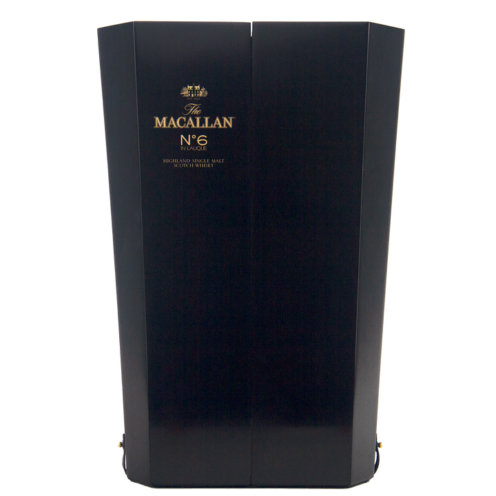 A tall, elegant dark wooden box with gold text reading "The Macallan No 6 Single Malt Scotch Whisky," highlighting its sherry cask maturation, displayed against a plain white background.