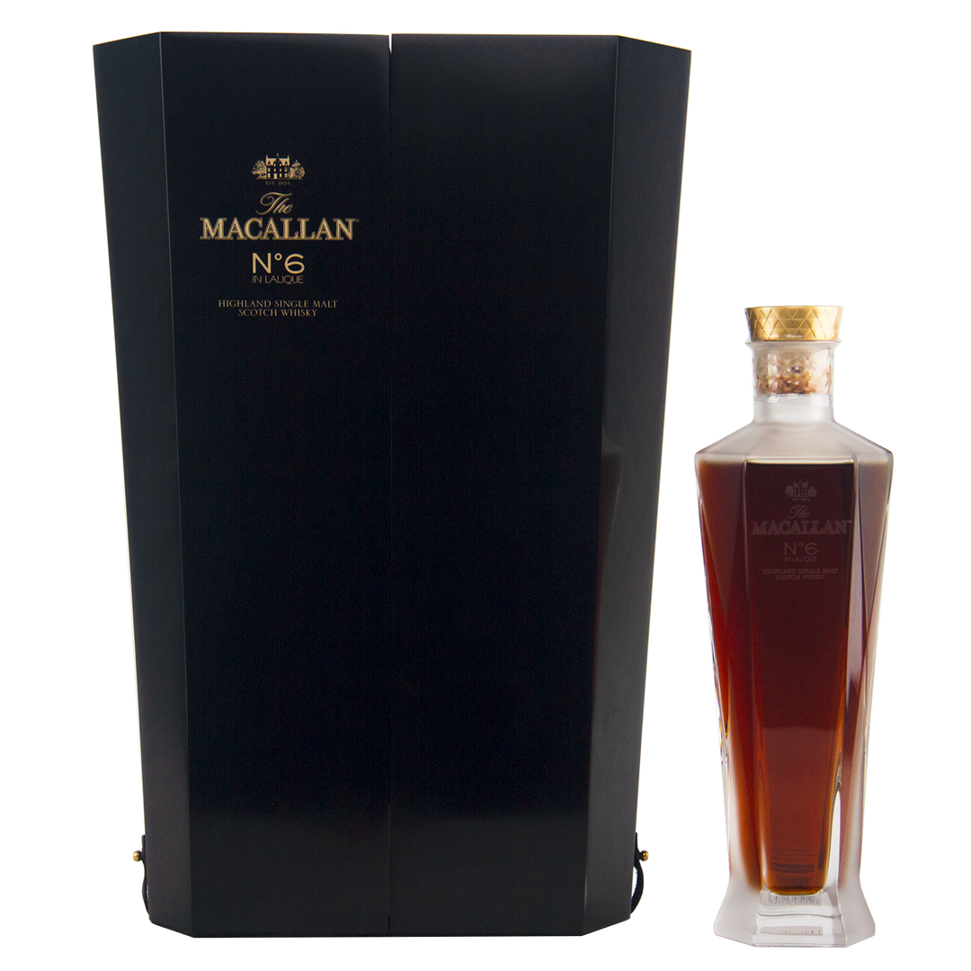 A bottle of The Macallan No 6 Single Malt Scotch Whisky, presented in a dark, elegant box with gold lettering and housed in a faceted decanter-style bottle topped with a gold cap.