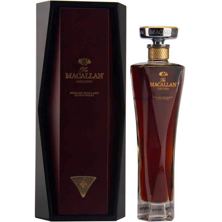 A tall, elegant bottle of The Macallan Oscuro Single Malt Scotch Whisky stands beside its matching dark, angular box with gold lettering and accents.