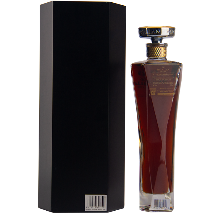 A tall, elegant bottle of The Macallan Oscuro Single Malt Scotch Whisky, matured in sherry-seasoned oak casks, stands next to a sleek black box—both shown from the back with barcode stickers—an exclusive travel retail release.