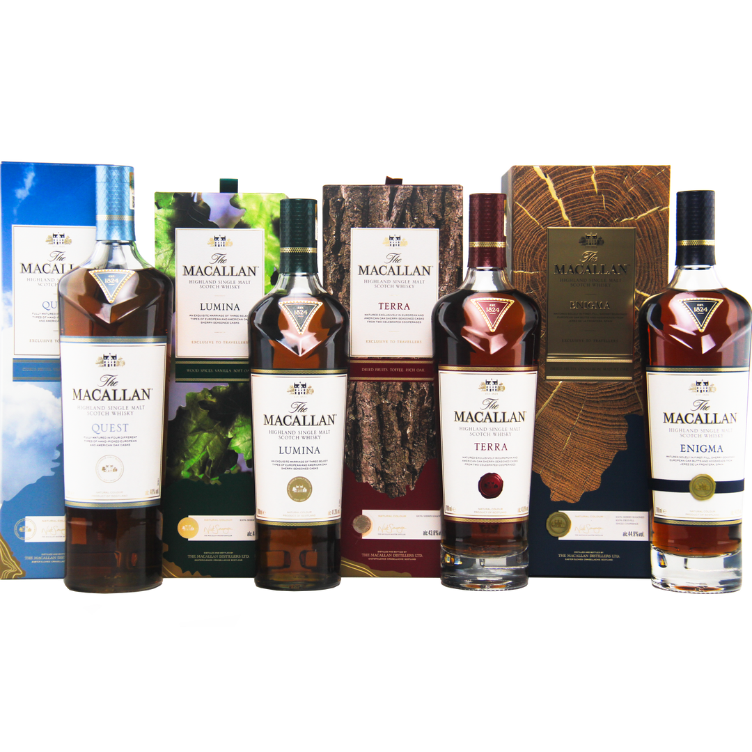 Five bottles of The Macallan Quest Complete Series Single Malt Scotch Whisky—Quest, Lumina, Terra, and Enigma—stand in a row as travel retail exclusives with sherry seasoned oak cask maturation and vibrant packaging.
