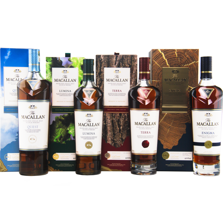 Five bottles of The Macallan Quest Complete Series Single Malt Scotch Whisky—Quest, Lumina, Terra, and Enigma—stand in a row as travel retail exclusives with sherry seasoned oak cask maturation and vibrant packaging.