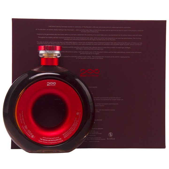 A round bottle of The Macallan Time Space Mastery Single Malt Scotch Whisky, with a red center, is displayed against a dark maroon background with white printed product details.