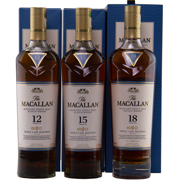 Three bottles of The Macallan Triple Cask 12, 15, and 18 stand with their boxes in a row, showcasing collectible whiskies from the renowned Macallan range.