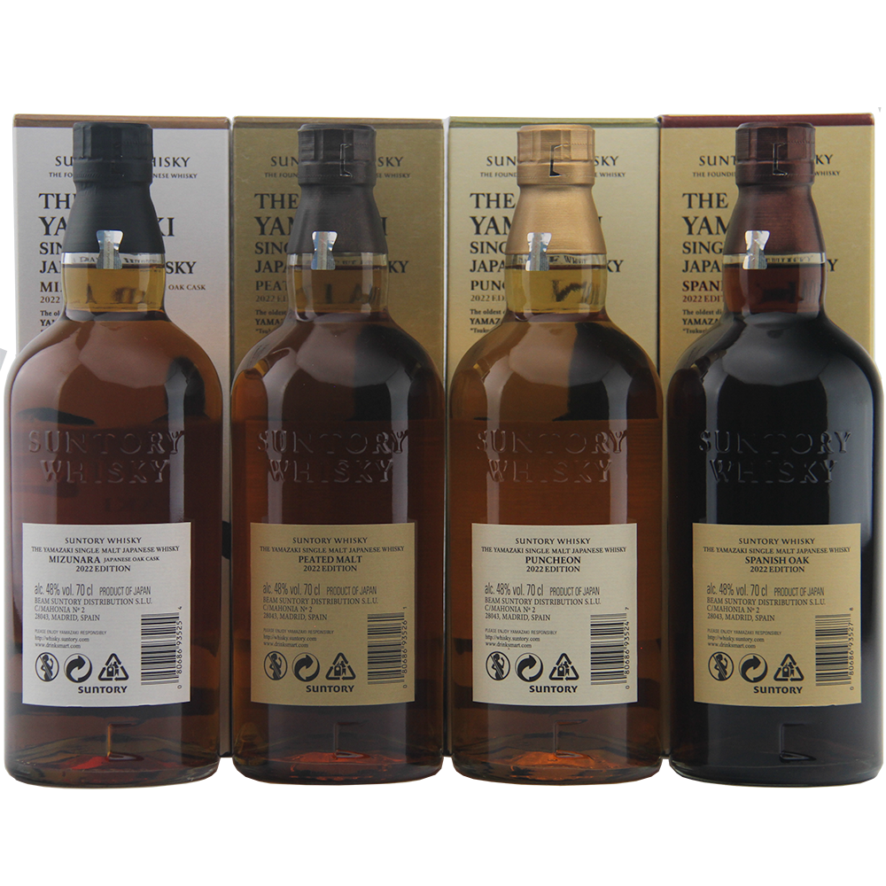 Four bottles of Suntory Whisky with their packaging on a white background