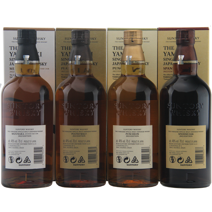 Four bottles of Suntory Whisky with their packaging on a white background