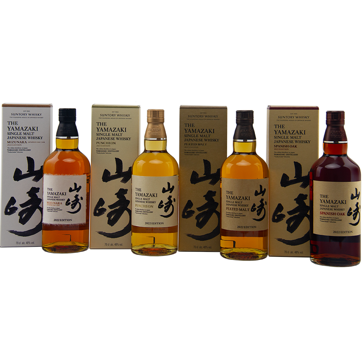 Four bottles of Yamazaki whisky with packaging on a white background