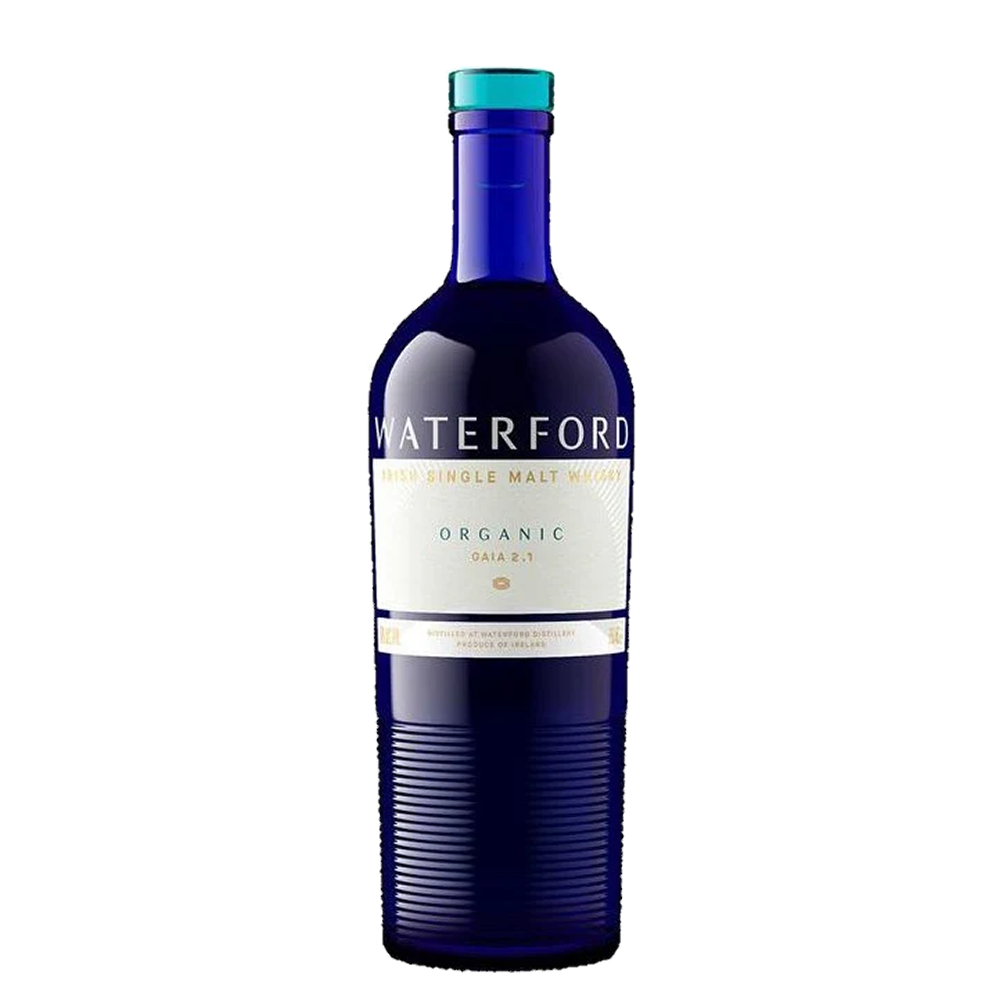 A blue glass bottle of Waterford Organic Gaia: Edition 2.1 Single Malt Whisky, made from organic Irish barley, has a white and gold label with blue and gold accents, shown against a plain white background.