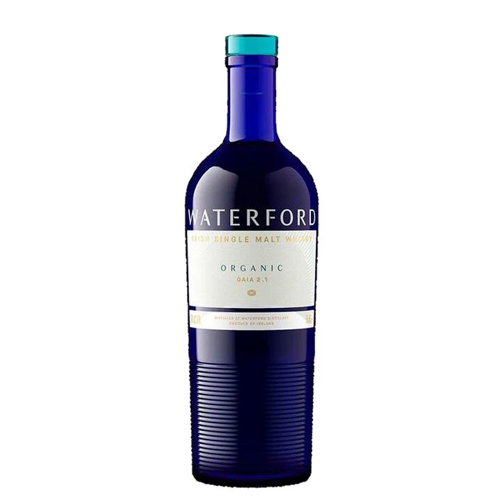 A blue glass bottle of Waterford Organic Gaia: Edition 2.1 Single Malt Whisky, made from organic Irish barley, has a white and gold label with blue and gold accents, shown against a plain white background.
