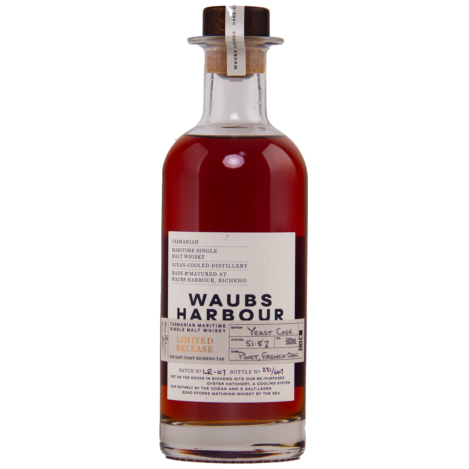 A clear glass bottle of Waubs Harbour Yeast Cask Single Malt Australian Whisky with a cork stopper. This deep amber, limited-edition Australian whisky is matured in a yeast cask, as described on the label.